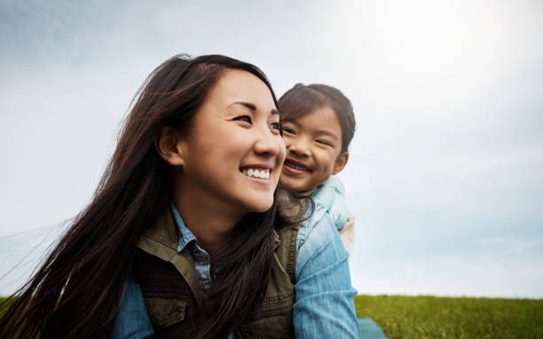 It's impossible to count how much I love you Shot of a mother bonding with her little daughter outdoors east asian ethnicity stock pictures, royalty-free photos & images