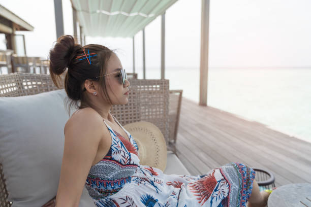 istock Asian beautiful woman enjoyful on sofa. 1001295500