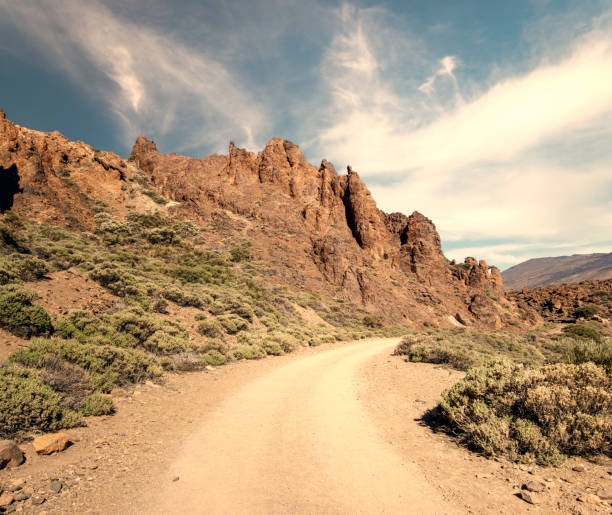 istock road through rocky desert around the volcano 1001295756