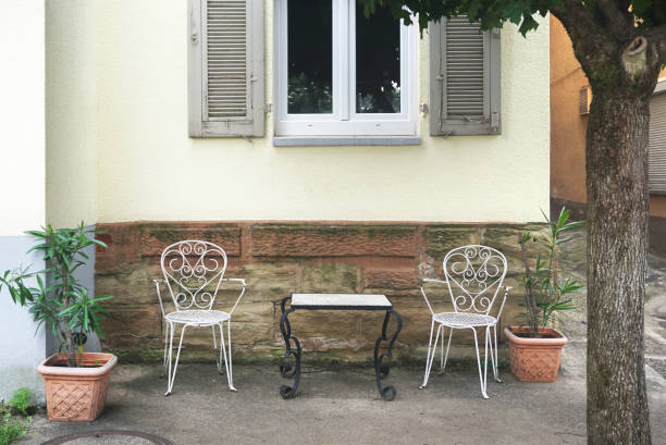 Empty street cafe with two white chairs and tables. Front view.