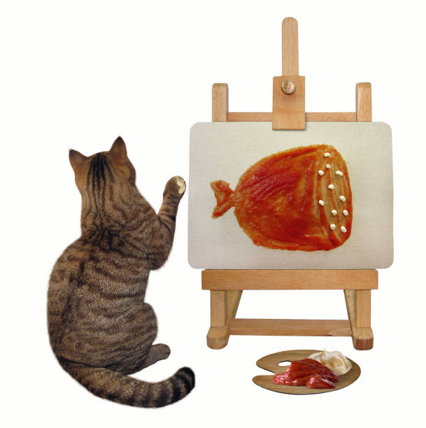 istock Cat draws a picture on the easel 1001299196