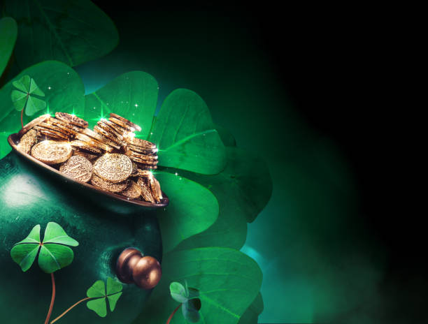 Pot of gold coins with four leaf clovers in the background