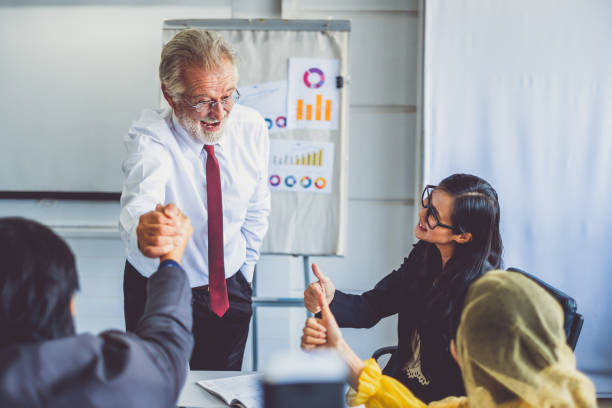 istock Group of diversity business people making handshake for teamwork and agreement concept, at meeting room in office 1001299872