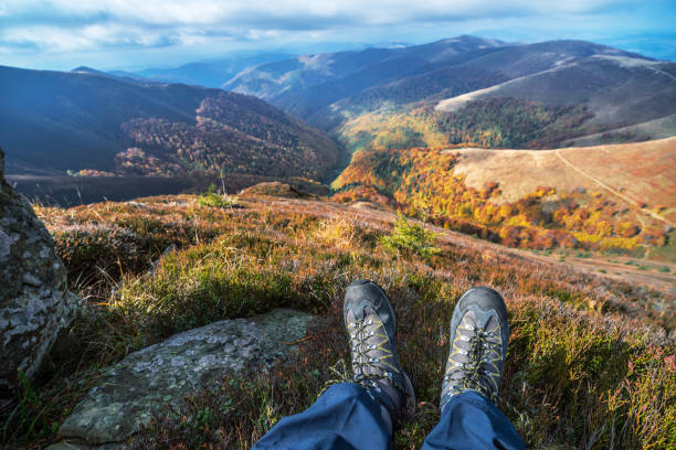 istock Hiker's boots and the mountain peaks at the background. 1001316534