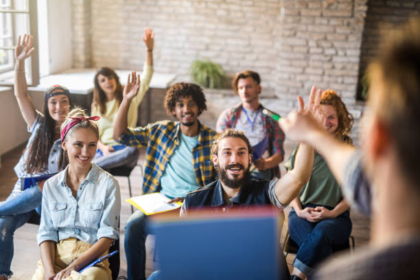 istock Happy freelance workers raising their arms on a training class in the office. 1001321680