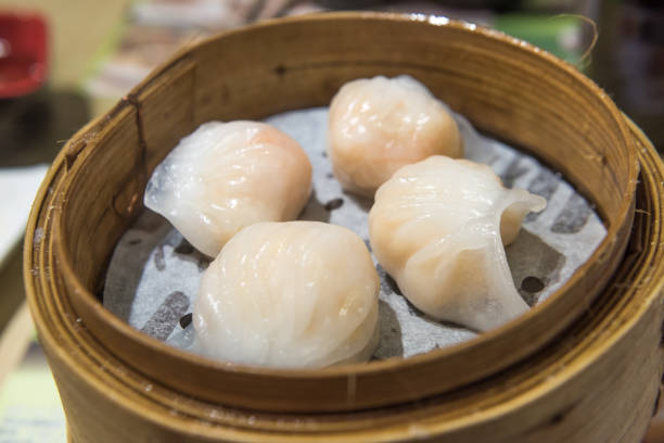 istock Dim Sum, traditional Cantonese dumplings, cooked in bamboo steamer 1001335734