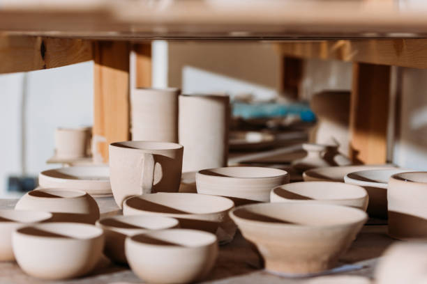 istock ceramic cups and bowls on wooden shelves in pottery workshop 1001335798
