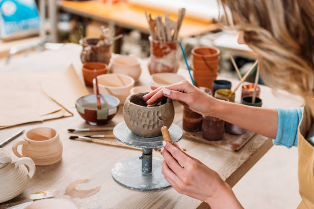 istock cropped view of woman decorating ceramic bowl in pottery workshop 1001341564