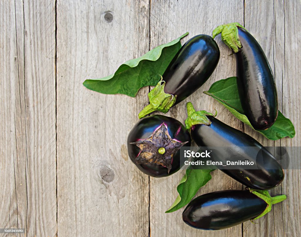 Ripe eggplants on a wooden background. Top view, flat lay. Eggplant Stock Photo