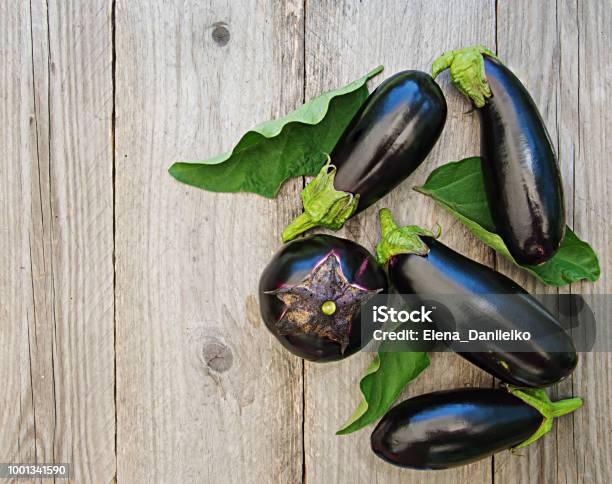 Ripe Eggplants On A Wooden Background Top View Flat Lay Stock Photo - Download Image Now