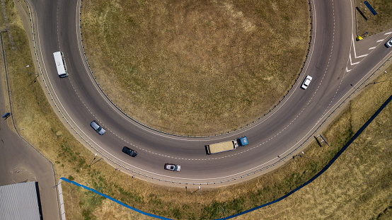 Aerial view of the vehicular intersection,  traffic at peak hour with cars on the road.