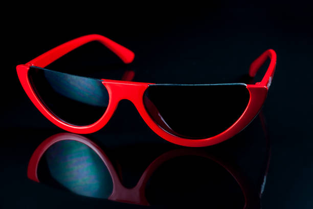 istock Red fashion sunglasses on a black background. 1001345408