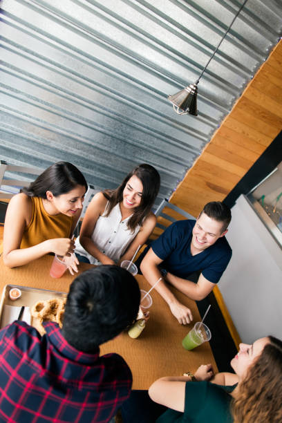 istock Friends sitting at table in restaurant 1001345910