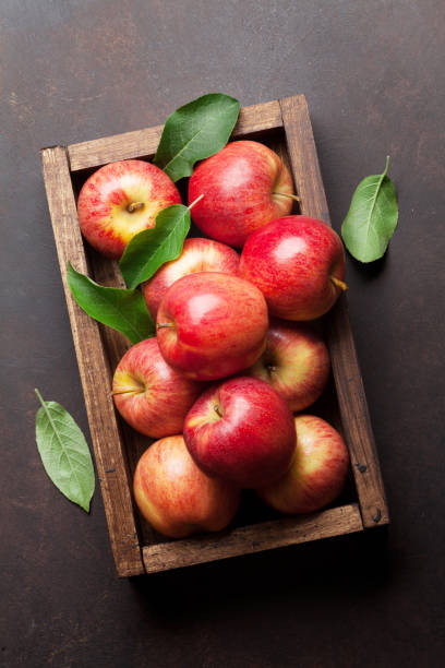 istock Red apples in wooden box 1001346360