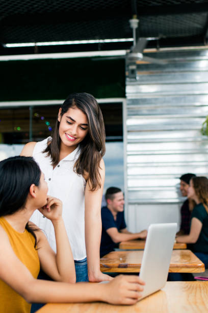 istock Two young women looking at laptop and smiling 1001349584