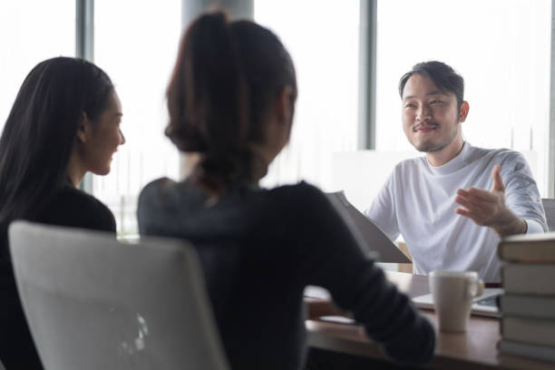 istock Smiling businessman during job interview.Job interview concept.Businessman explaining and listen to candidate answers 1001351792