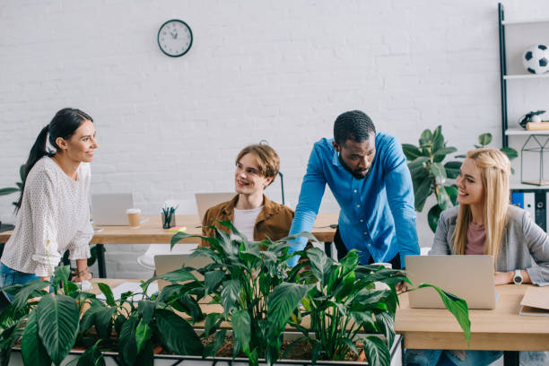 istock multiethnic businesspeople working at table with laptops in modern office 1001354366