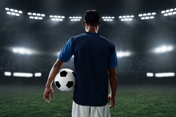 istock Soccer player holding soccer ball 1001354778