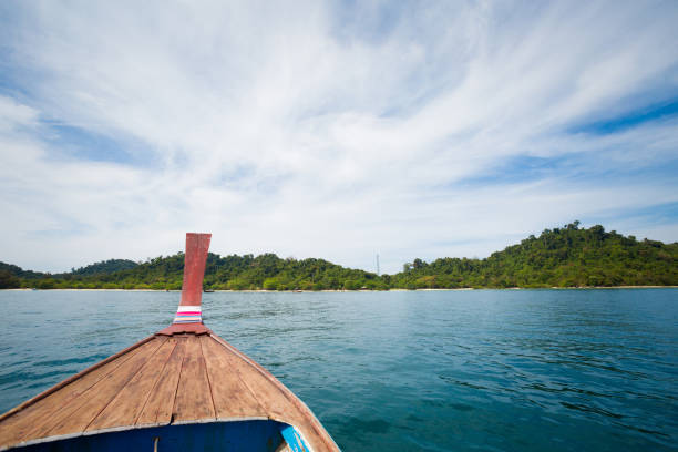 Longtail boat on tropical koh Kradan island  in Thailand. Landscape taken on main long sunrise beach with blue sky and white sand.