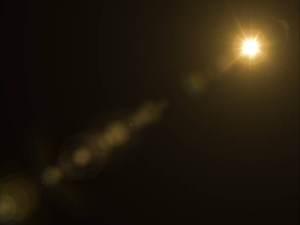 istock Abstract sun burst with digital lens flare light over black background 1001358778