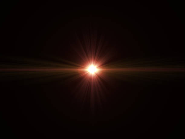 Abstract sun burst with digital lens flare light over black background stock photo