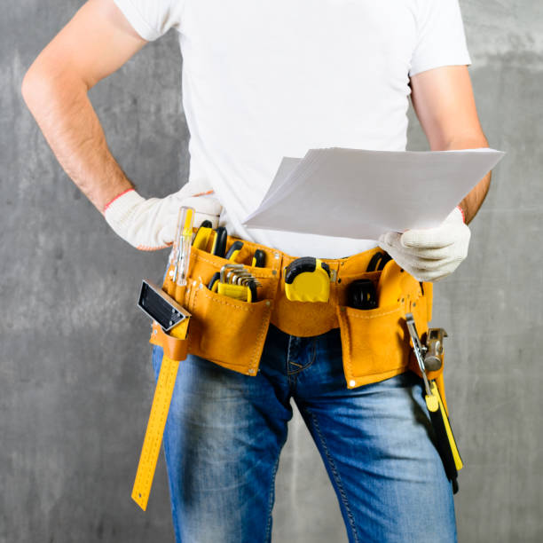 istock front view of unknown handyman with hand on waist and tool belt 1001359048