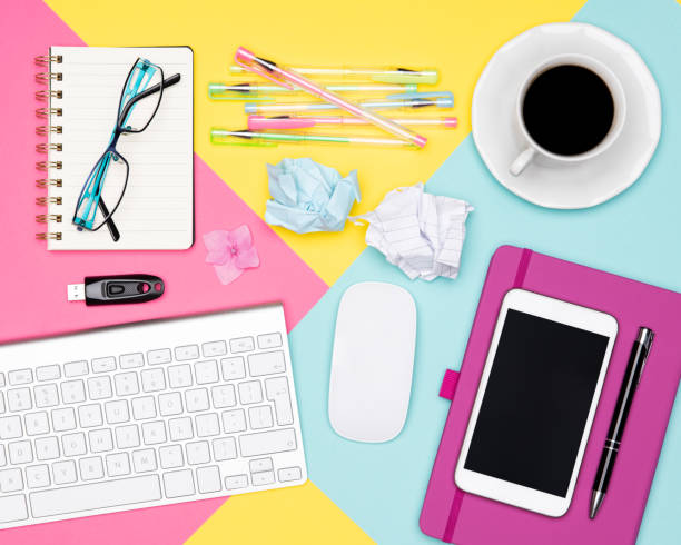 istock Office Desk Working Space Flat Lay. Top view photo of workspace with keyboard, notepad and coffee cup on pastel background. Pastel color working desk concept. 1001367216