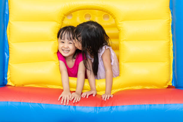 istock Asian Little Chinese sisters playing at inflatable castle 1001369930