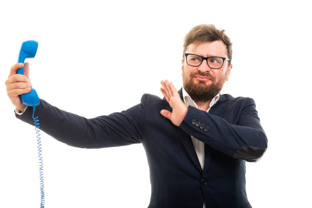istock Business man holding blue receiver and showing stop screaming gesture 1001371150