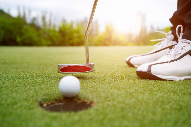 istock Golfer focus putting golf ball into the hole. 1001379192
