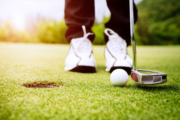 istock Golfer focus putting golf ball into the hole. 1001379276