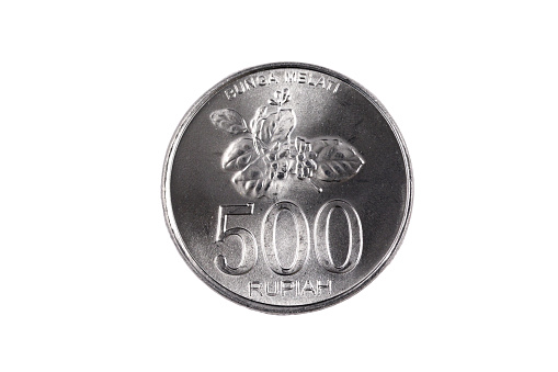 An extreme close up of an Indonesian 500 rupiah coin on a solid white background
