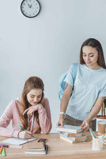 istock multicultural girls studying together at table 1001382834