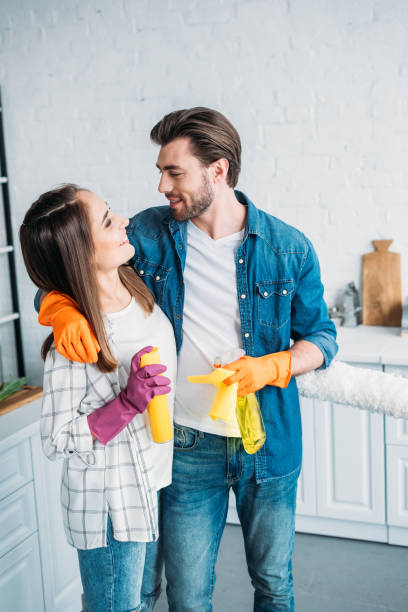 istock happy couple hugging during cleaning kitchen 1001385538