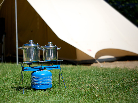 Cooking outdoors with gas stove on camping site