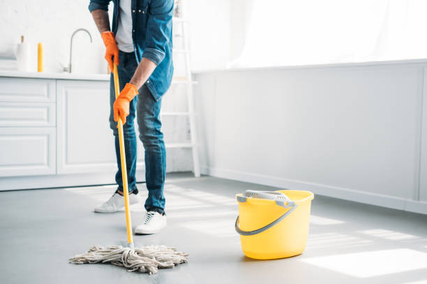 istock cropped image of man cleaning floor in kitchen with mop 1001385694