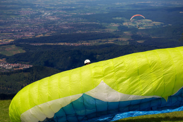 Paraglider preparing his parachute before taking off