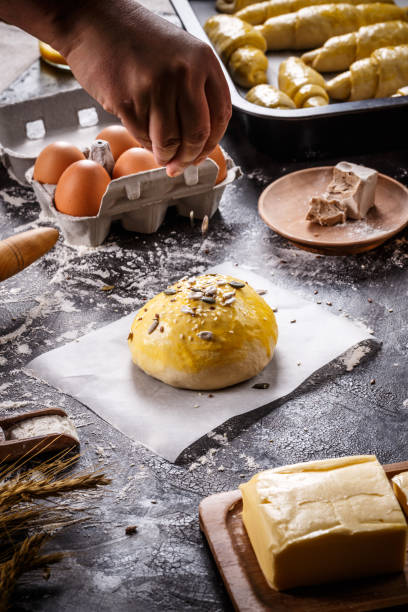Sprinkling mix of seeds over homemade bun