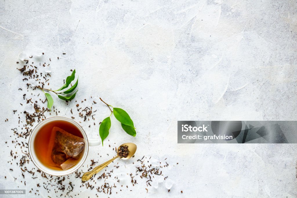 Top view of a cup of tea Top view of a cup of tea with tea bag, space for your text Dried Tea Leaves Stock Photo