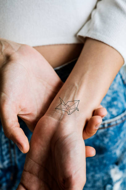 primo posto di tatuaggio sul polso di una donna - arm tattoo foto e immagini stock