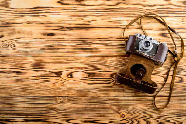 istock Old retro vintage old-fashioned camera in leather case on wooden 1001400778