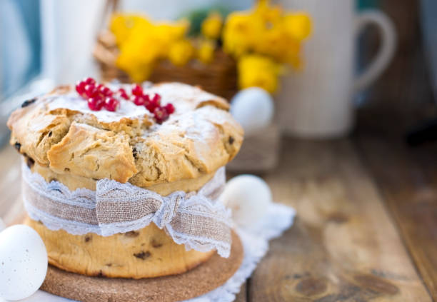 istock Easter cupcake with berries on the table near the window. Fresh spring flowers. Copy space 1001401848