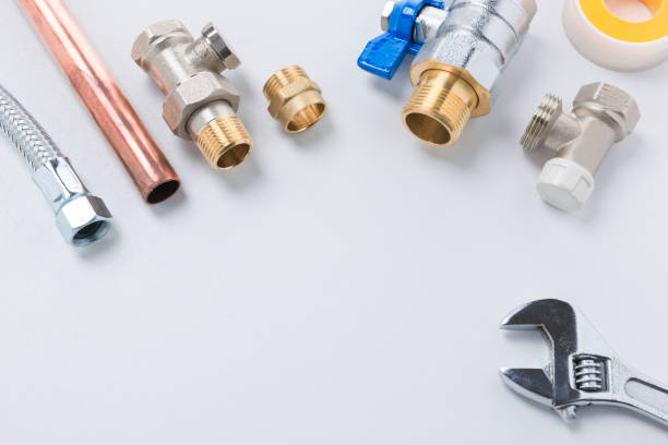 istock Pipes, Fittings, Seal Tape, and Spanner on White Background with Copy Space 1001404574