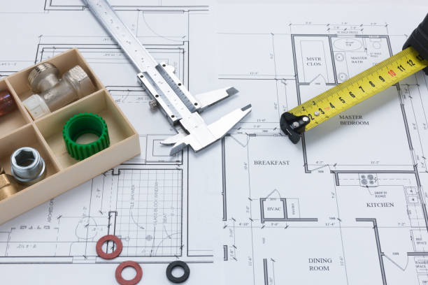 istock Tape Measure, Caliper, Pipe Joints and Washers on Architectural Plan Background 1001404896