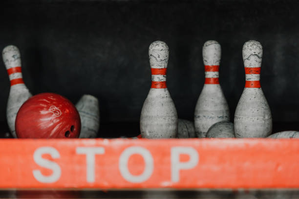 istock bowling ball crushing pins behind stop sign 1001405990