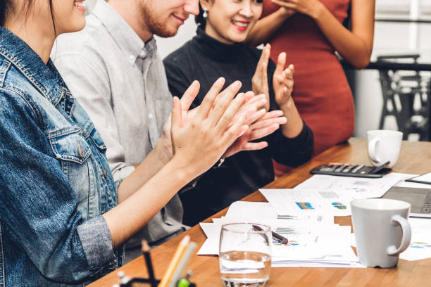 istock Successful business people clapping hands in the meeting 1001412782