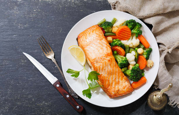 istock plate of baked salmon steak with vegetables 1001414188