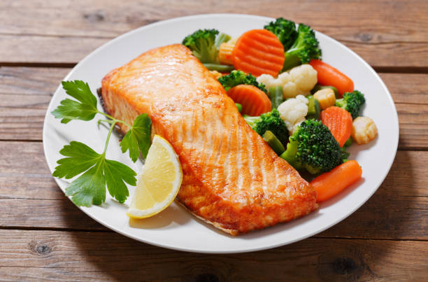 istock plate of baked salmon steak with vegetables 1001414202