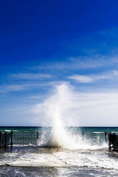 istock Sea water splashes at old pier on sunny day 1001414452