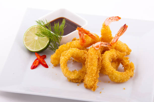 istock Shrimps fried in hot fan with sauce and a lime. 1001418866